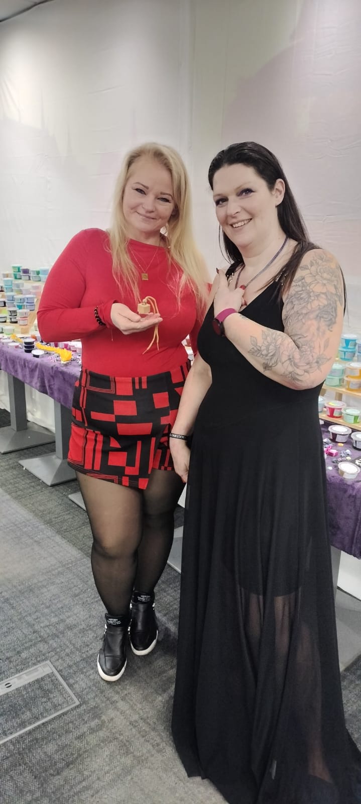 Lisa with a customer holding a wooden car air freshener at a craft fair